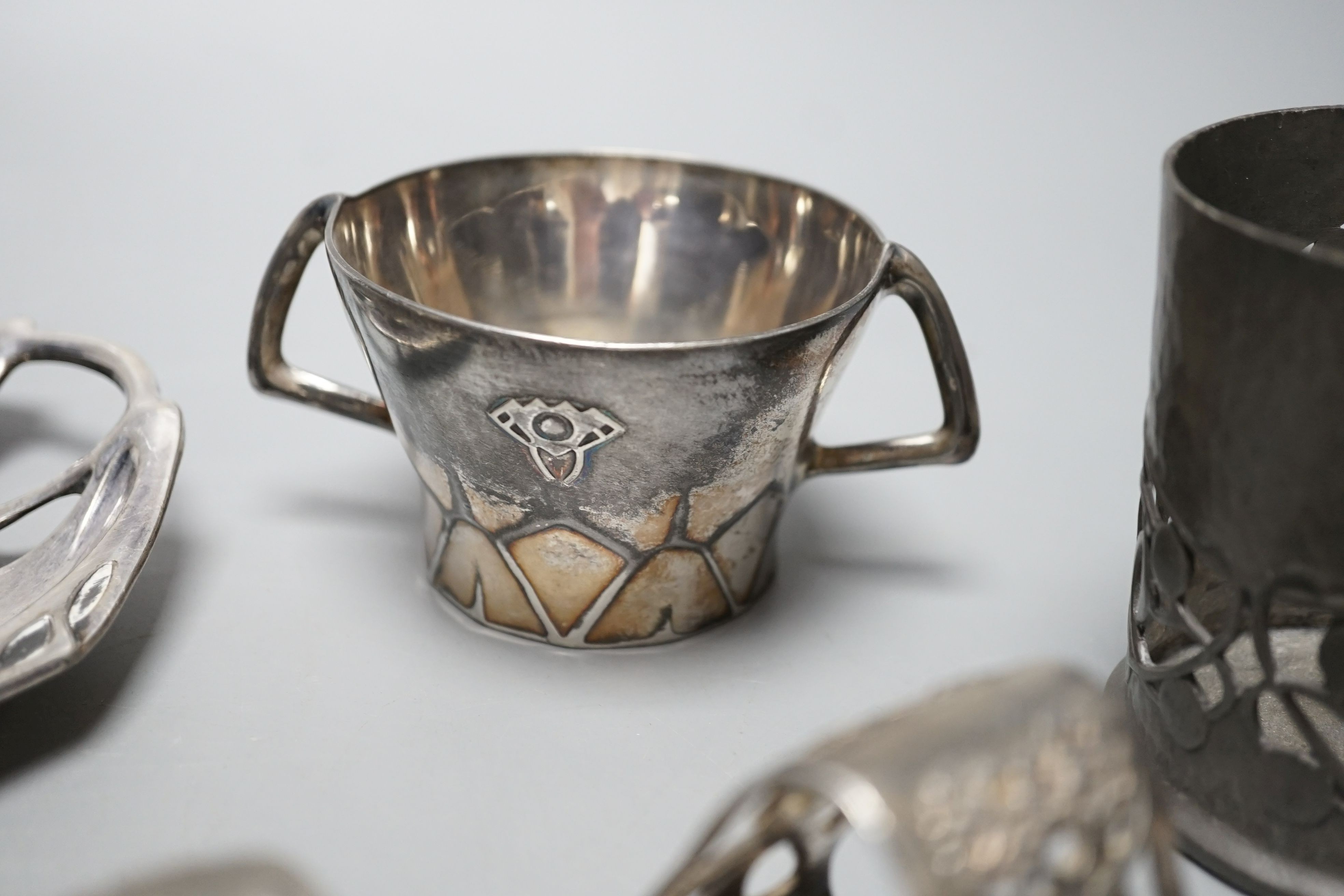 An Arts and Crafts Tudric pewter mug, stamped 534, a pair of WMF napkin rings together with other pewter and metal items, pewter mug 8cms high (9)